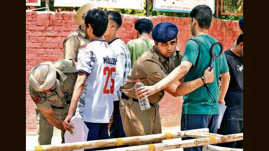Candidates-undergo-frisking-at-an-exam-centre-in-S_1782069826214