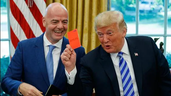 President-Donald-Trump-holds-up-a-red-card-during-_1783442715909