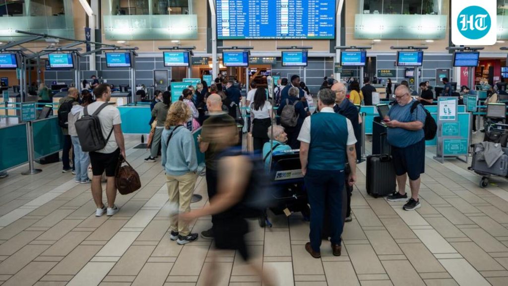 Travellers-wait-at-the-check-in-at-Vancouver-Inter_1786006562159